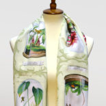 Scarf printed with paintings of extinct frog species in terrariums by artist Ashley Cecil